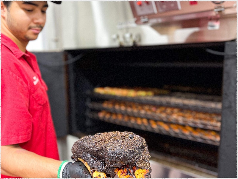 Porter - Meet the Team – 61 man pulling out meat from smoker